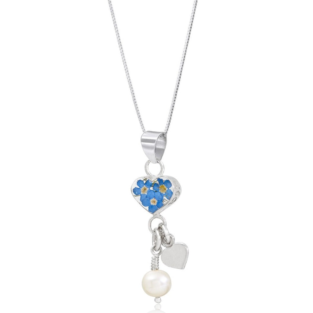 A silver snake chain with a silver bound resin heart which encapsulates some real forget-me-not flowers. Dangling from the main heart is a mini silver heart charm and a pearl charm.  Comes on an 18 inch adjustable sterling silver chain.
