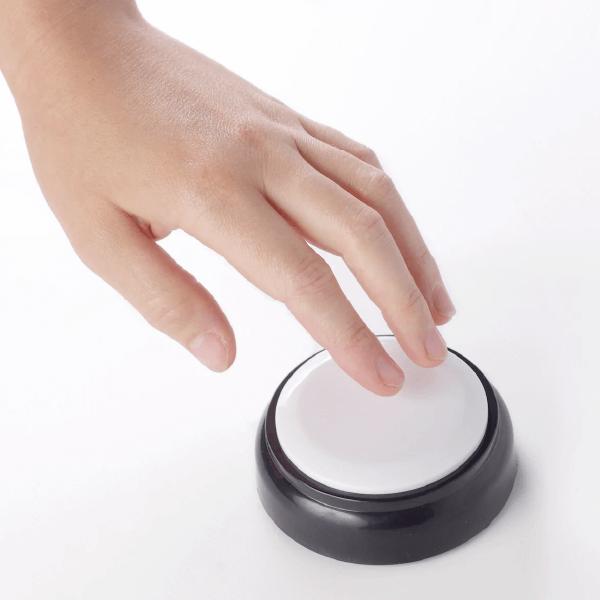 A hand pressing an assistive product button