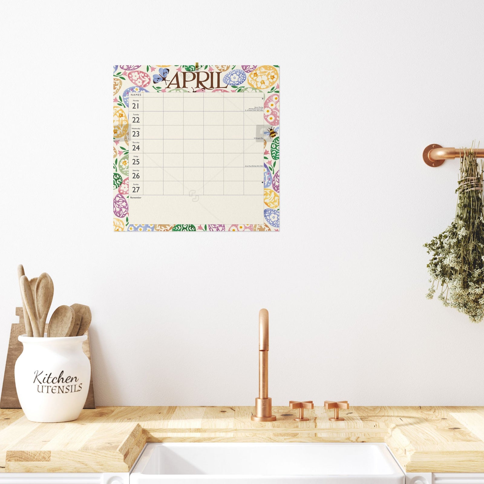 A calendar hung on a wall in a lovely hallway.