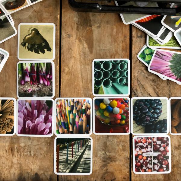 Scattered cards with photographic close-up images on a wooden backdrop