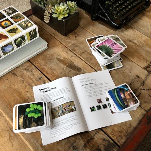 Scattered cards with photographic close-up images on a wooden backdrop with gameplay instructions