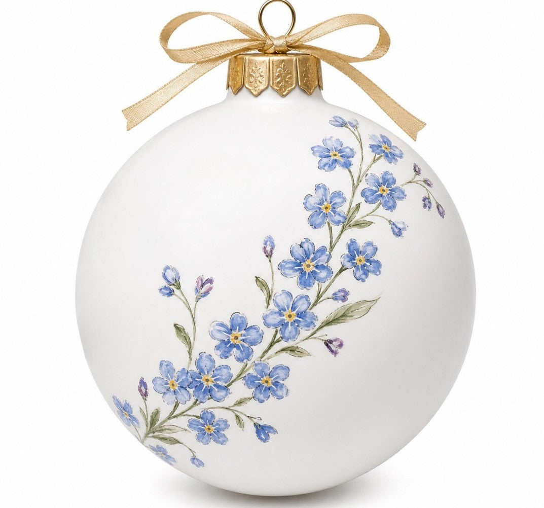 Beautiful hand-painted forget-me-not garland on a white ceramic bauble with a gold hanging hoop and gold ribbon tied in a bow.