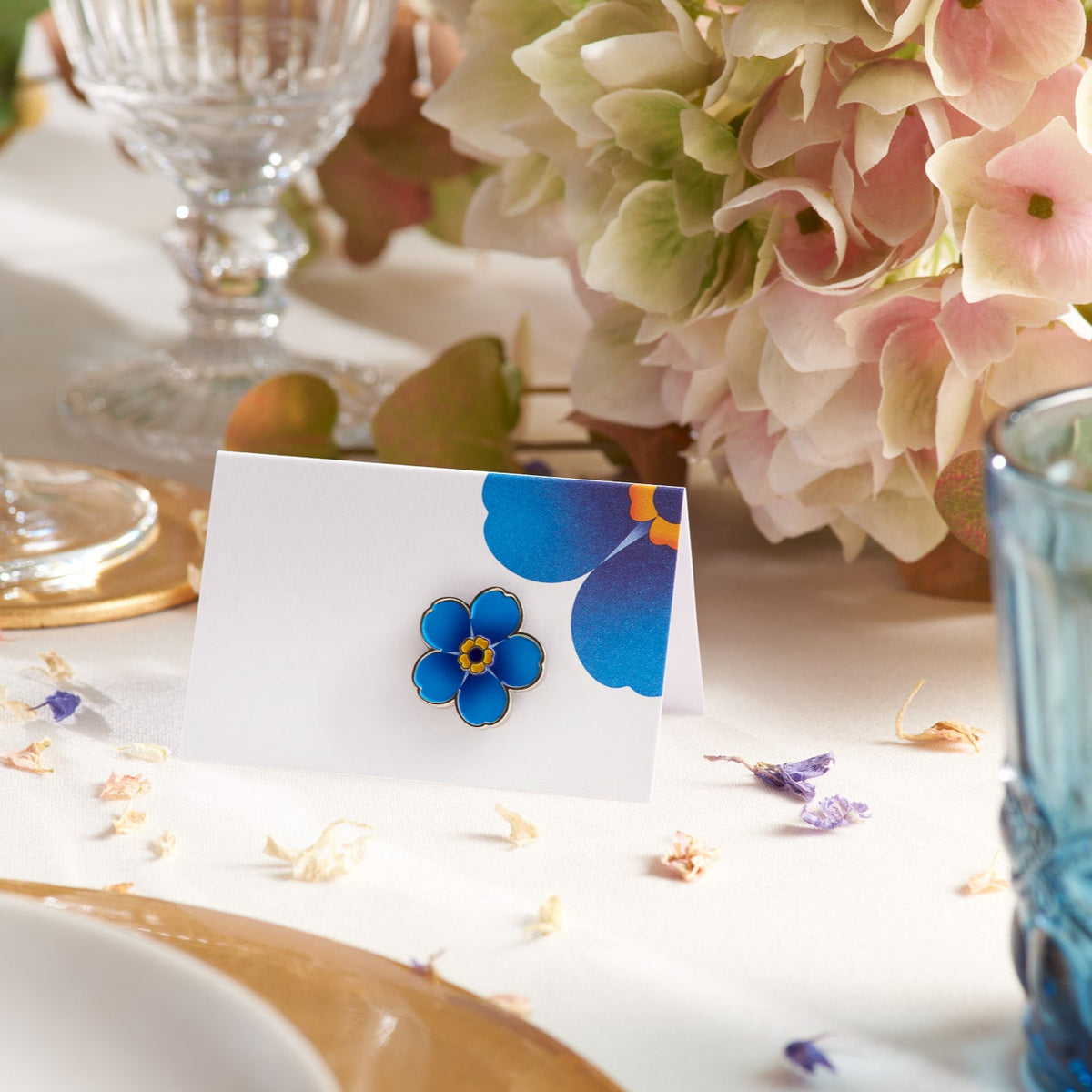 Enamel Alzheimer&#39;s Society flower favour pin on a table card