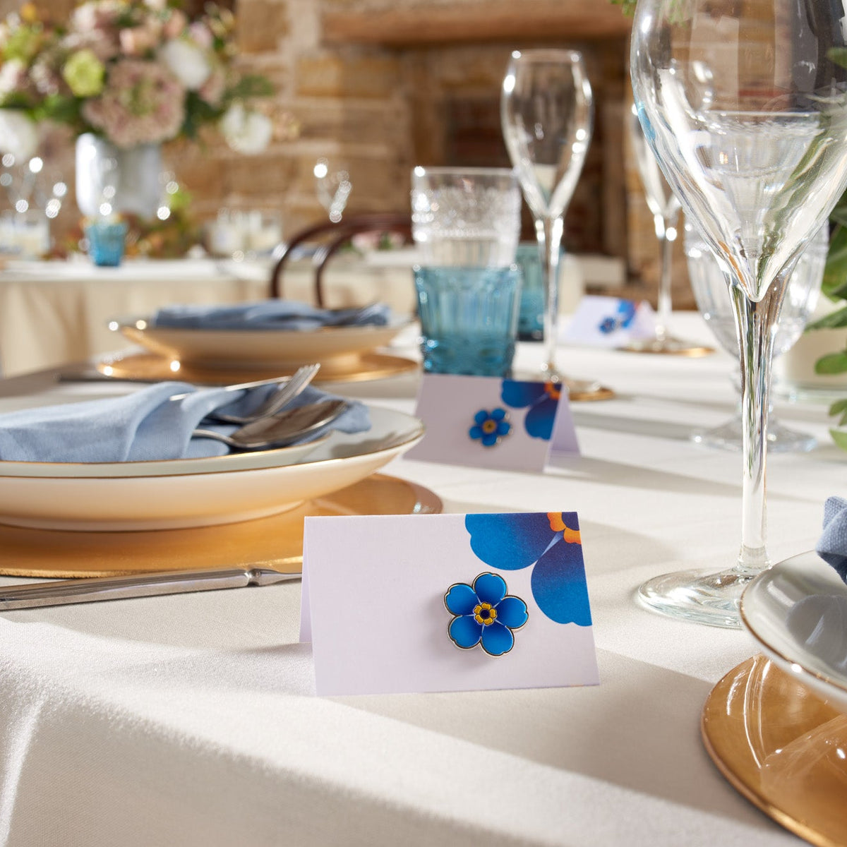 Enamel Alzheimer&#39;s Society flower favour pin on a table card