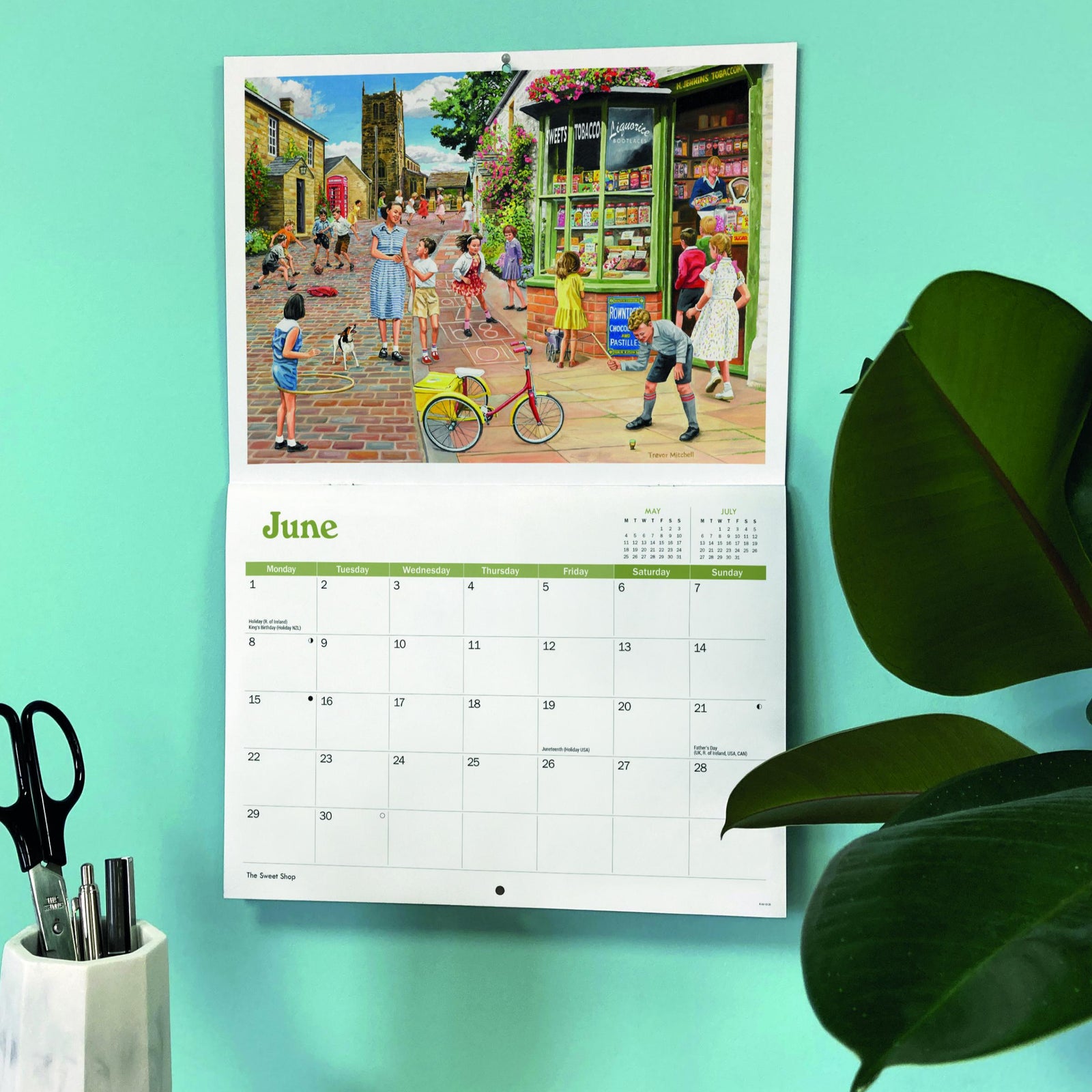 Calendar with a colorful illustration of a street scene on a teal background