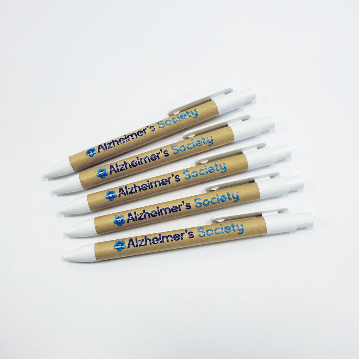 Five white Alzheimer's Society ballpoint pens with recycled cardboard barrel and blue flower logo and name