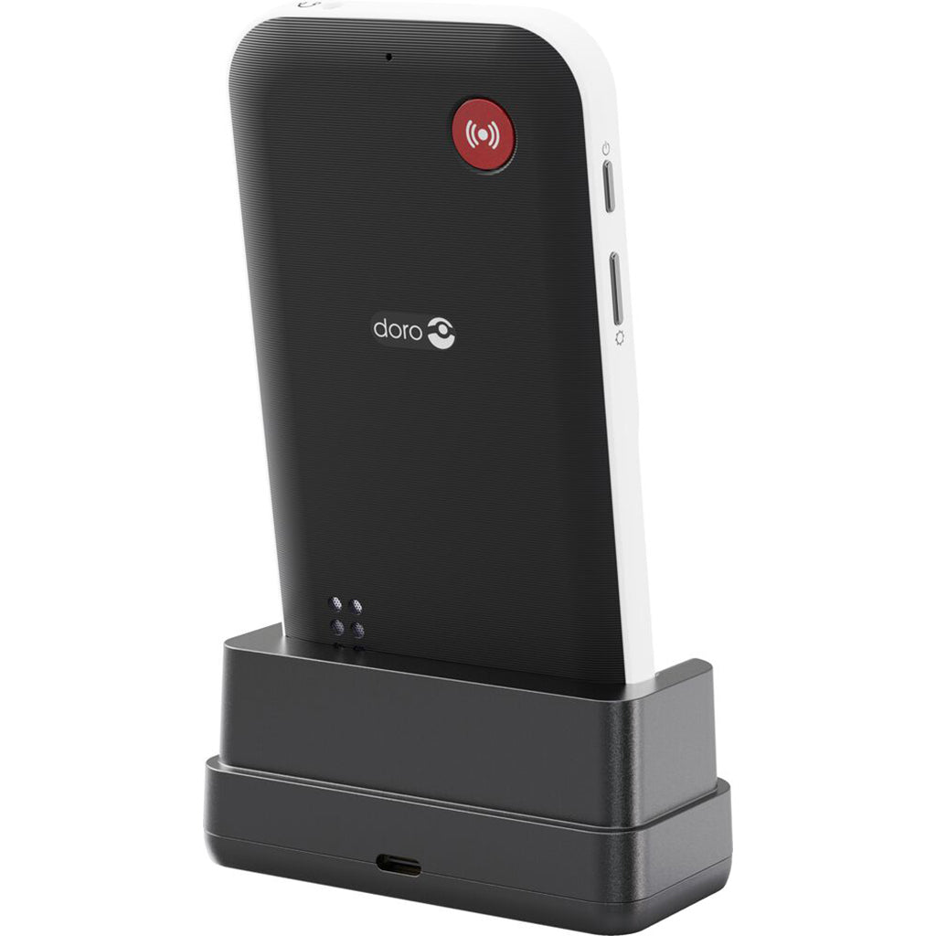 Reverse of small 4 button mobile phone for ease of use sat in charging cradle