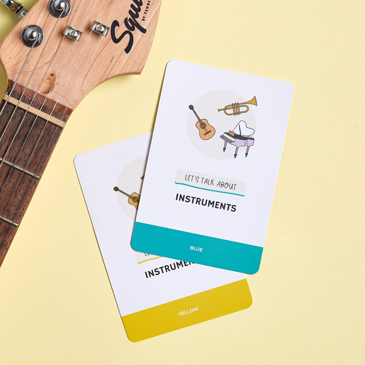 Topic card - lets talk about instruments, with a guitar next to it.