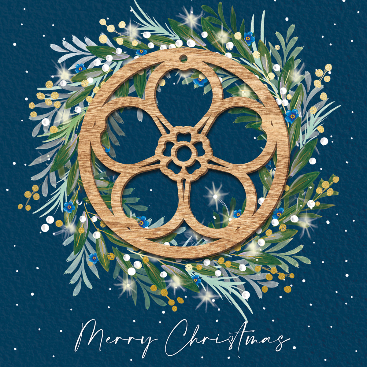 Winter wreath on a night sky blue background with a wooden cut out forget-me-not decoration in the centre.