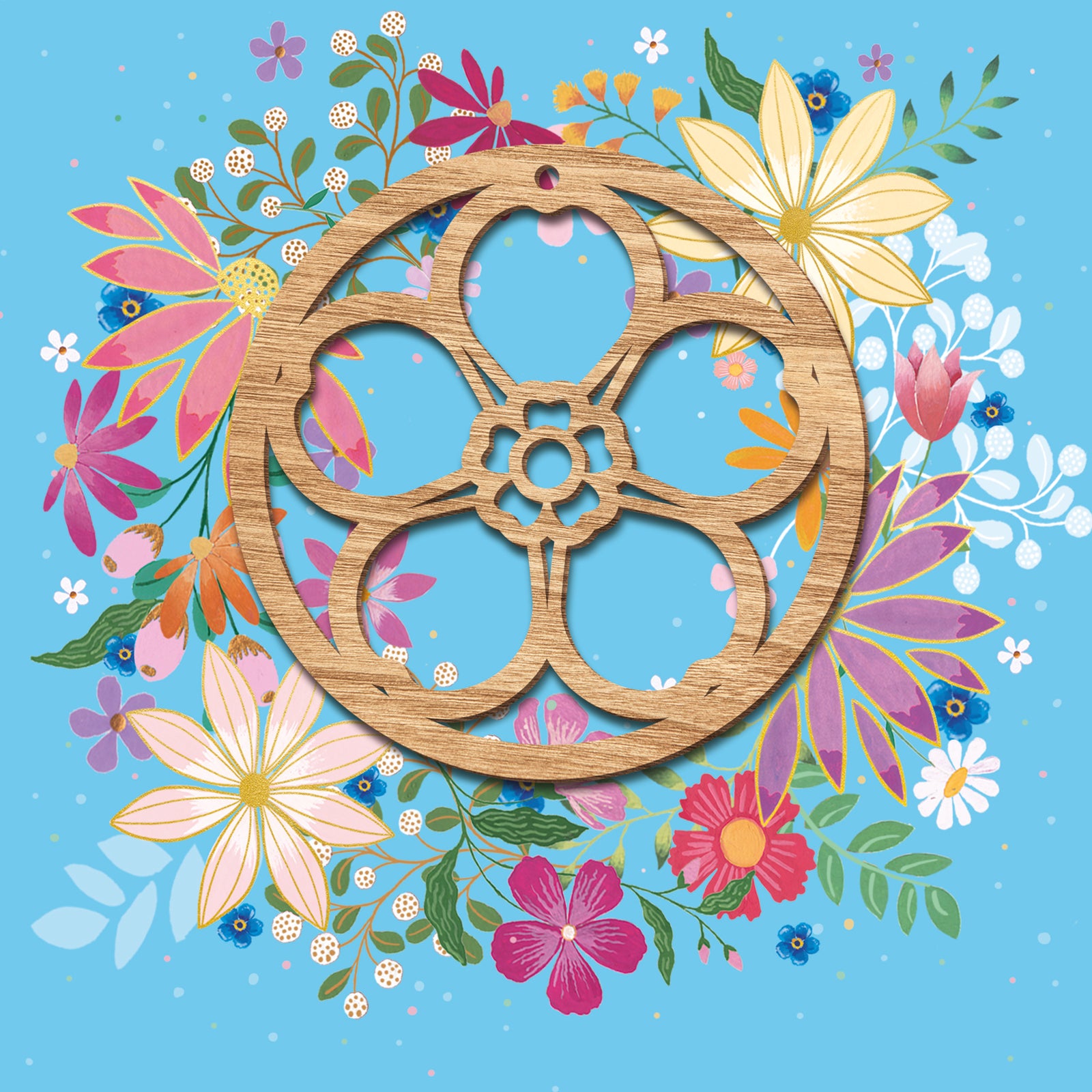 Floral wreath on a forget-me-not blue background with a wooden cut out forget-me-not decoration in the centre.