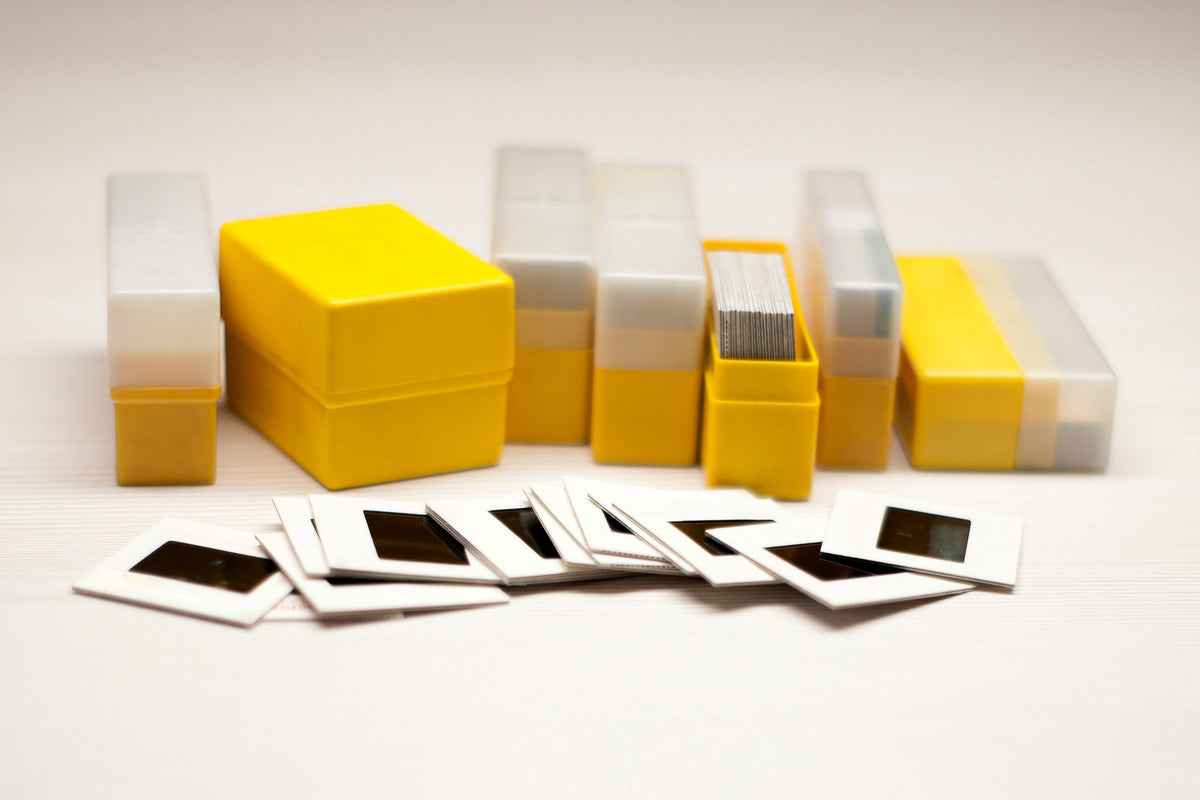 Collection of negative slide boxes and slides on a white background