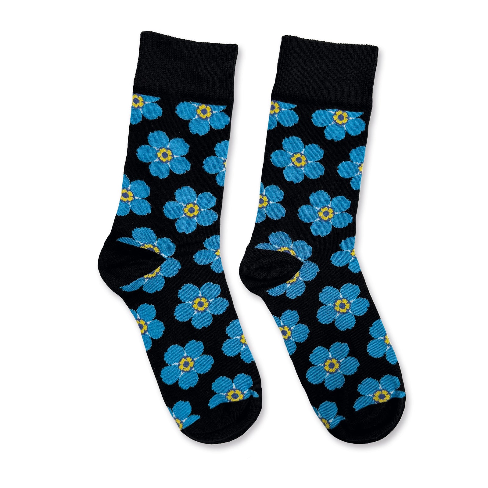 Blue Forget-me-not flowers on black crew socks on a white background