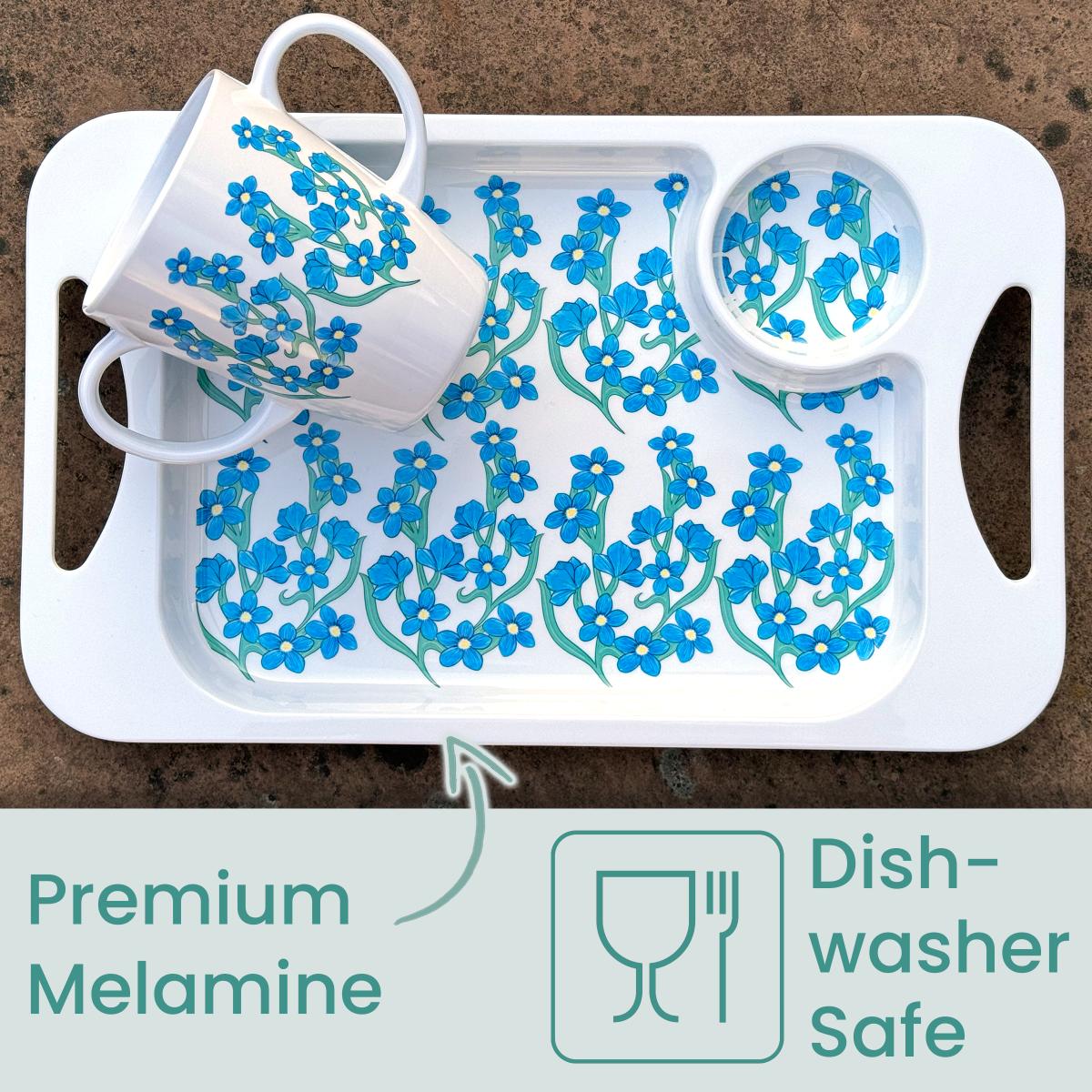White tray with floral design holding a mug and small cup holder space on a brown background