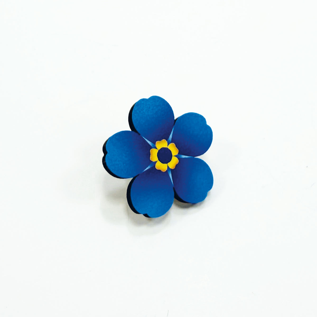 A large wooden forget-me-not on a white background
