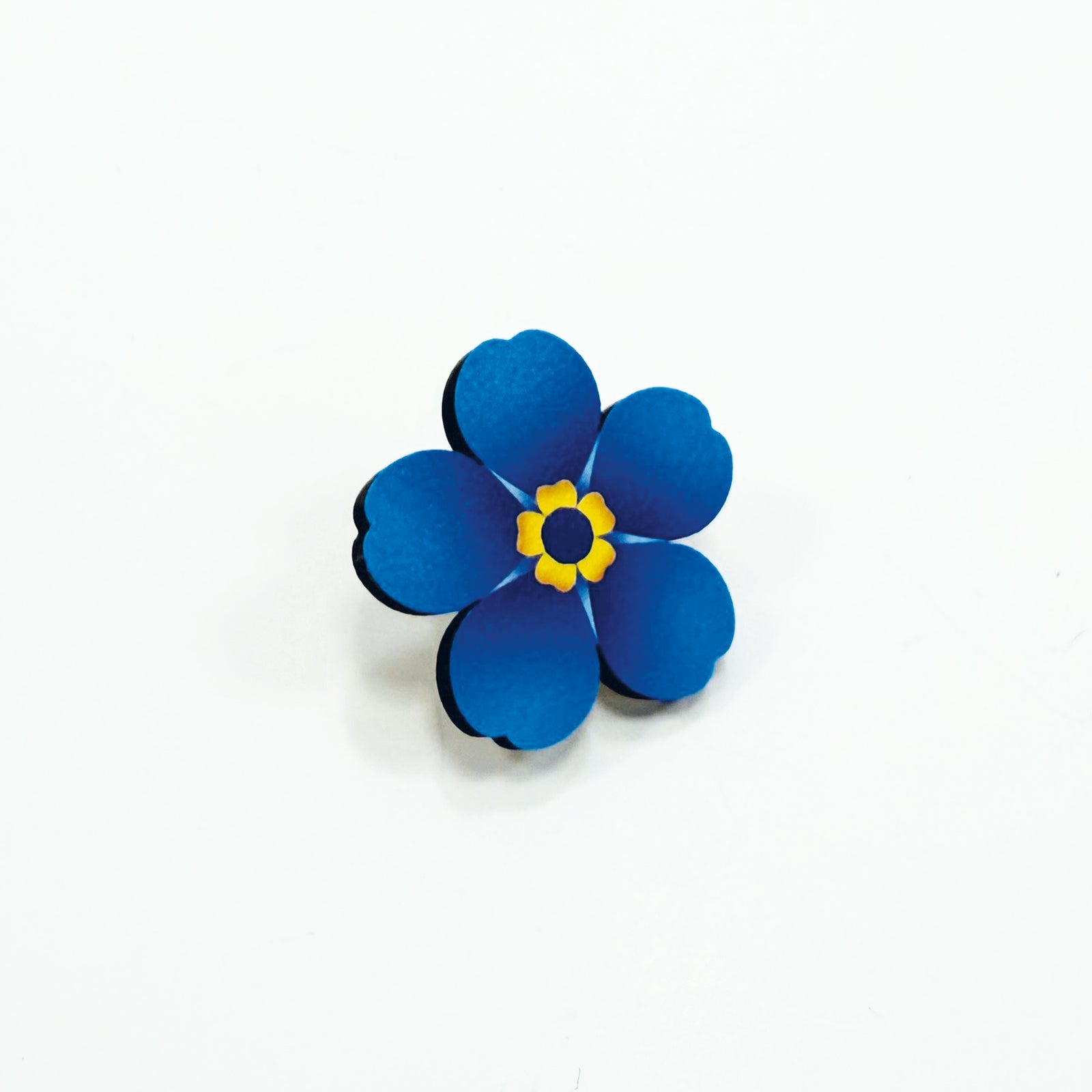A large wooden forget-me-not on a white background