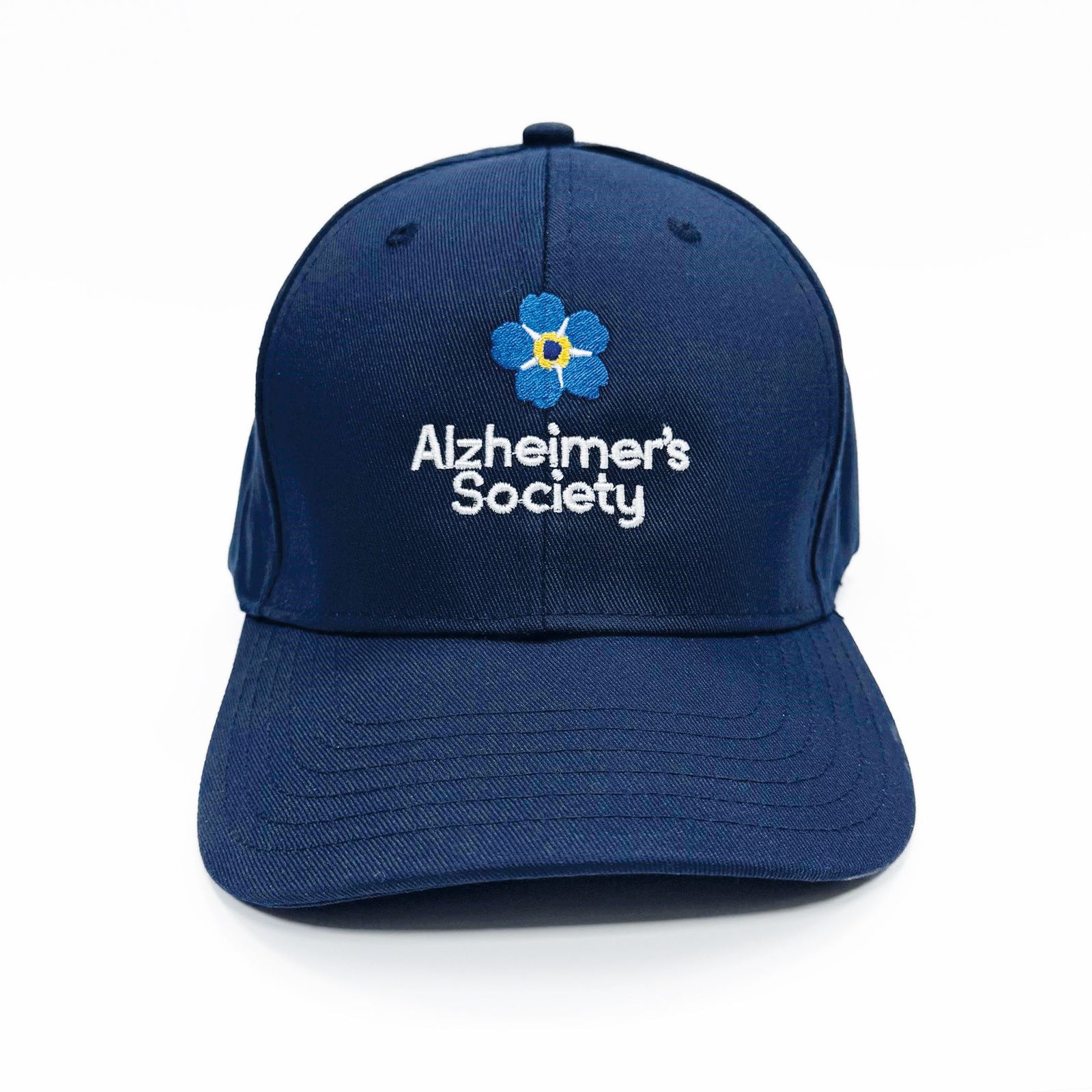 Blue baseball cap with embroidered forget-me-not flower and white writing Alzheimer's Society