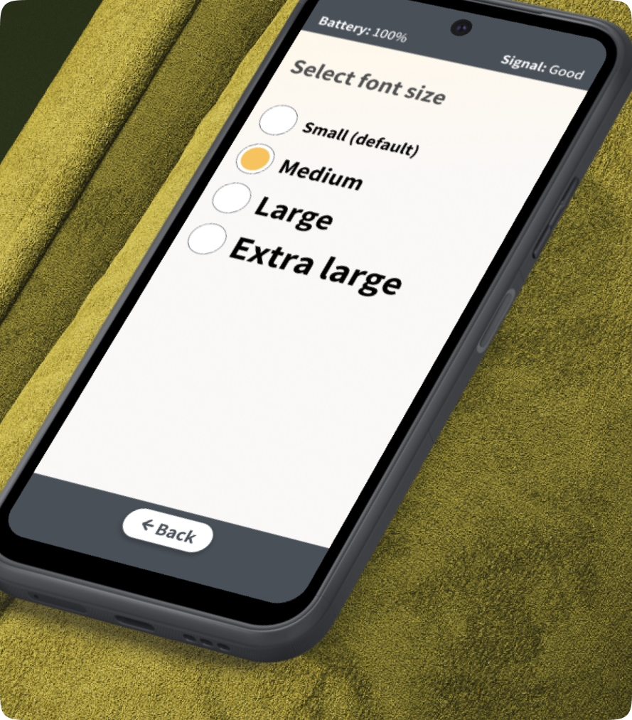 Smartphone displaying font size selection on a green textured surface