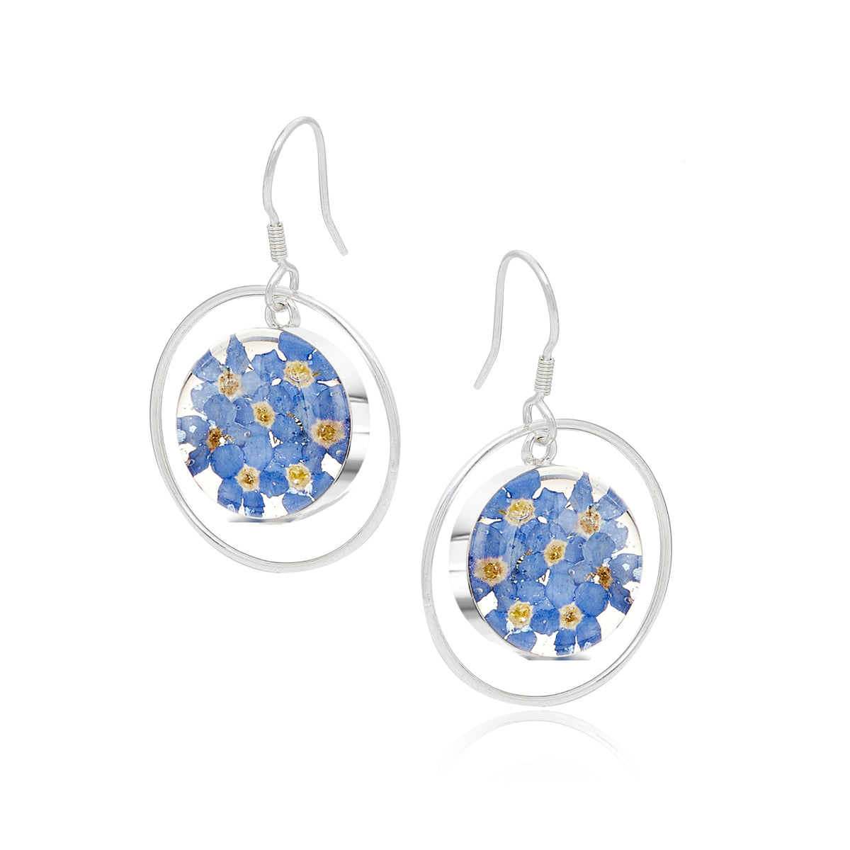 Forget-me-not silver circle earrings, photographed on a white background.