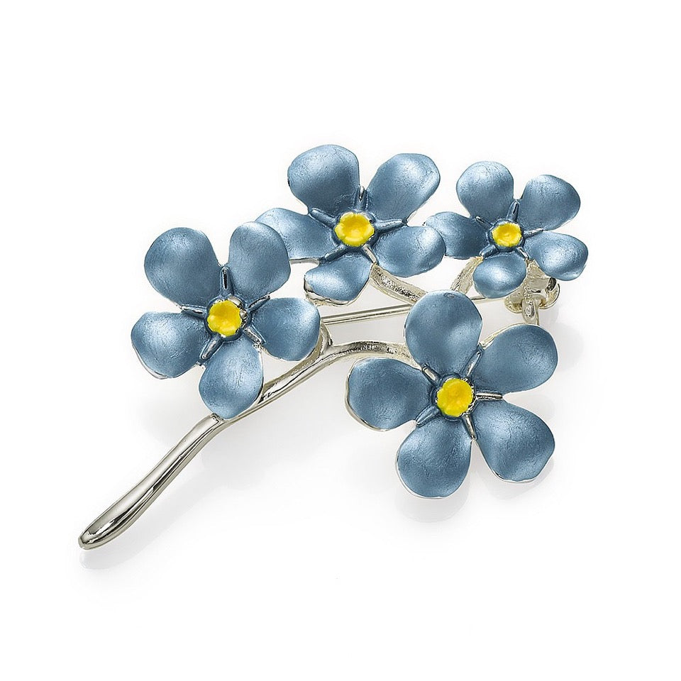 A forget-me-not brooch sliver plated on a white background