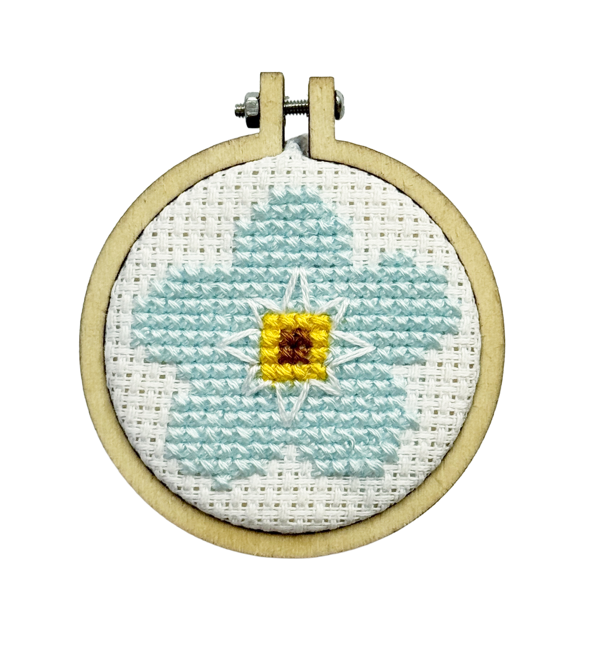 A completed Forget-me-not round cross stitch keyring