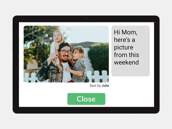 Digital display showing a family photo with a message from Julie, on a white background.