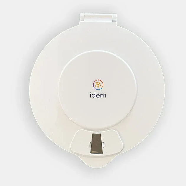 White idem pill dispenser with a small window in the dispenser.