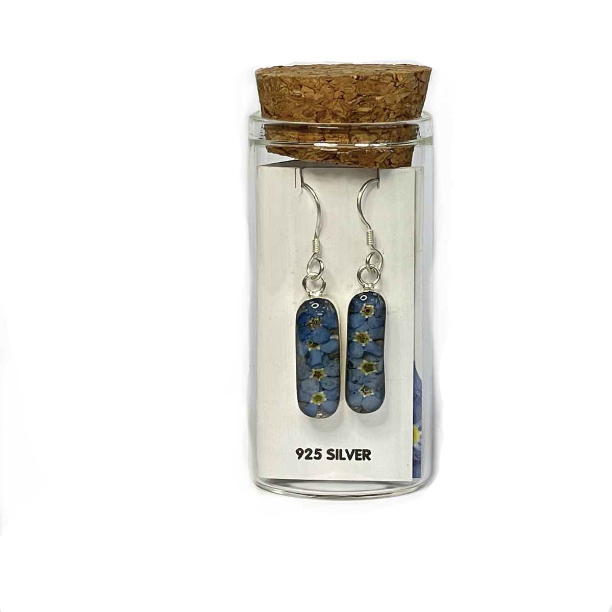 Silver lozenge shaped forget-me-not earrings on a dangle drop earring piece on white card, presented in a glass keepsake bottle with cork lid.