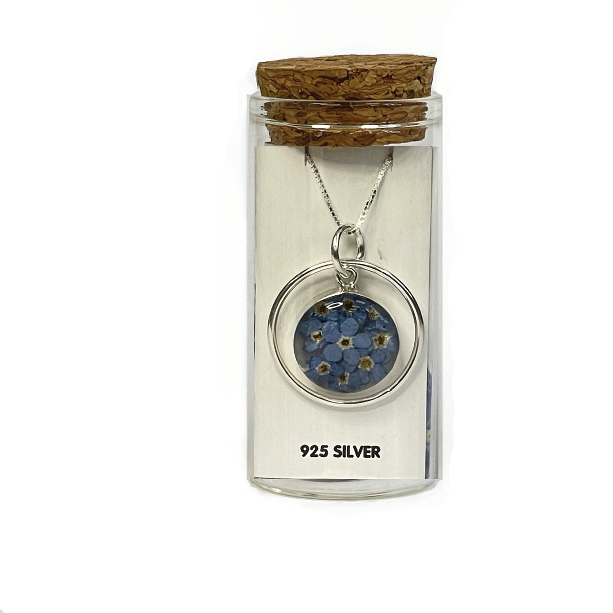 Round forget-me-not circle pendant, on a white card and presented in a glass keepsake bottle with cork lid.