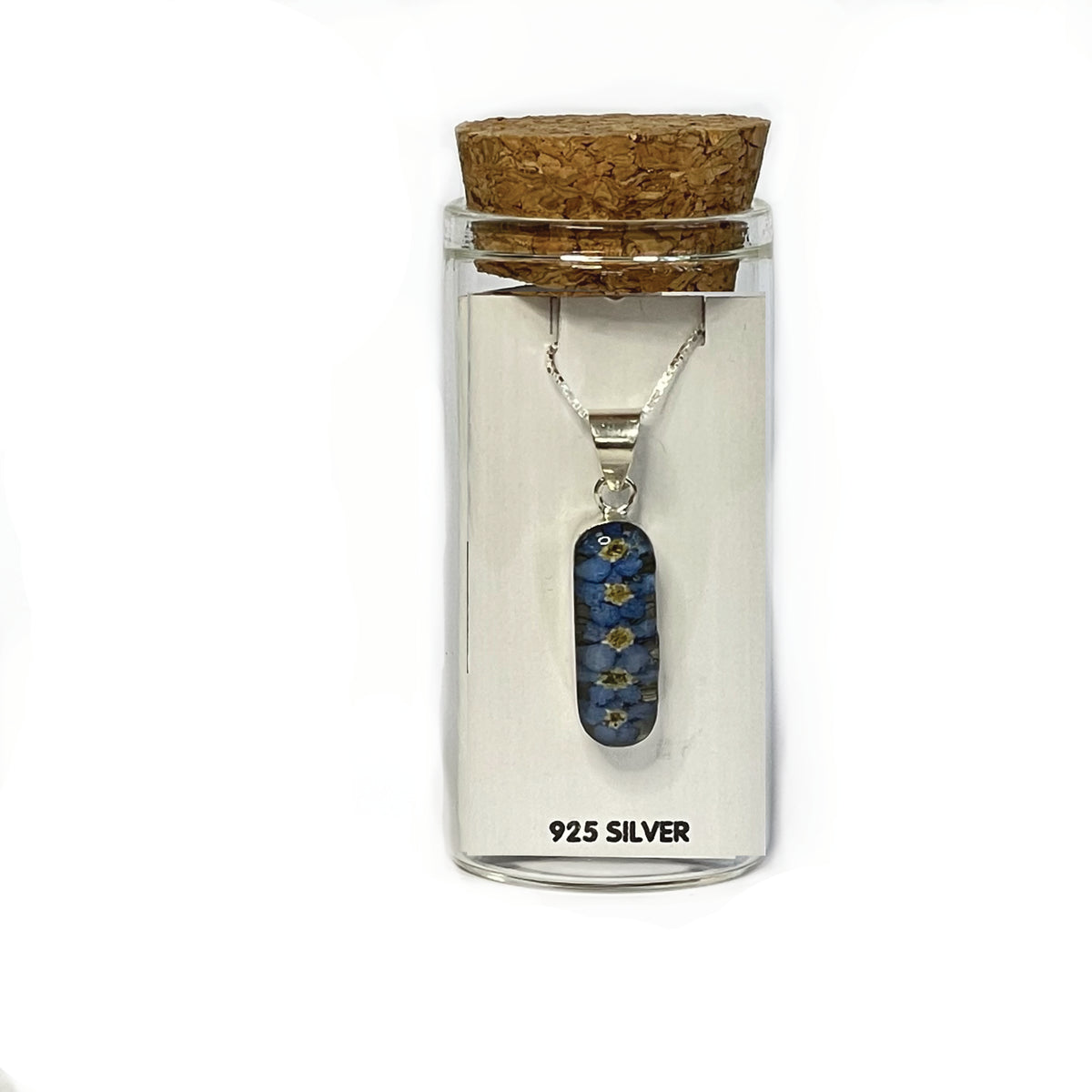 Forget-me-not lozenge pendant on a silver chain, presented on a white card in a glass keepsake bottle with cork lid.