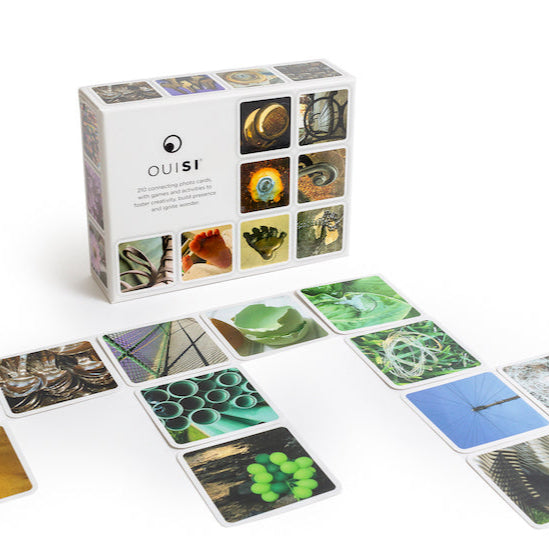 White boxed game showing game play of cards with photographic close-up images