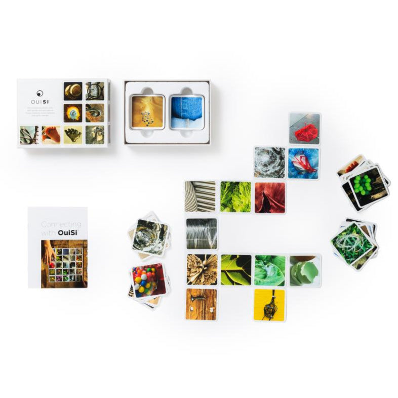 Scattered cards with photographic close-up images on a wooden backdrop with gameplay instructions