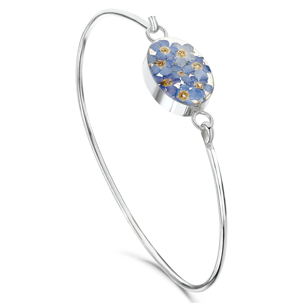 Sterling silver bangle with central sterling silver oval filled with real forget-me-not flowers set in resin.