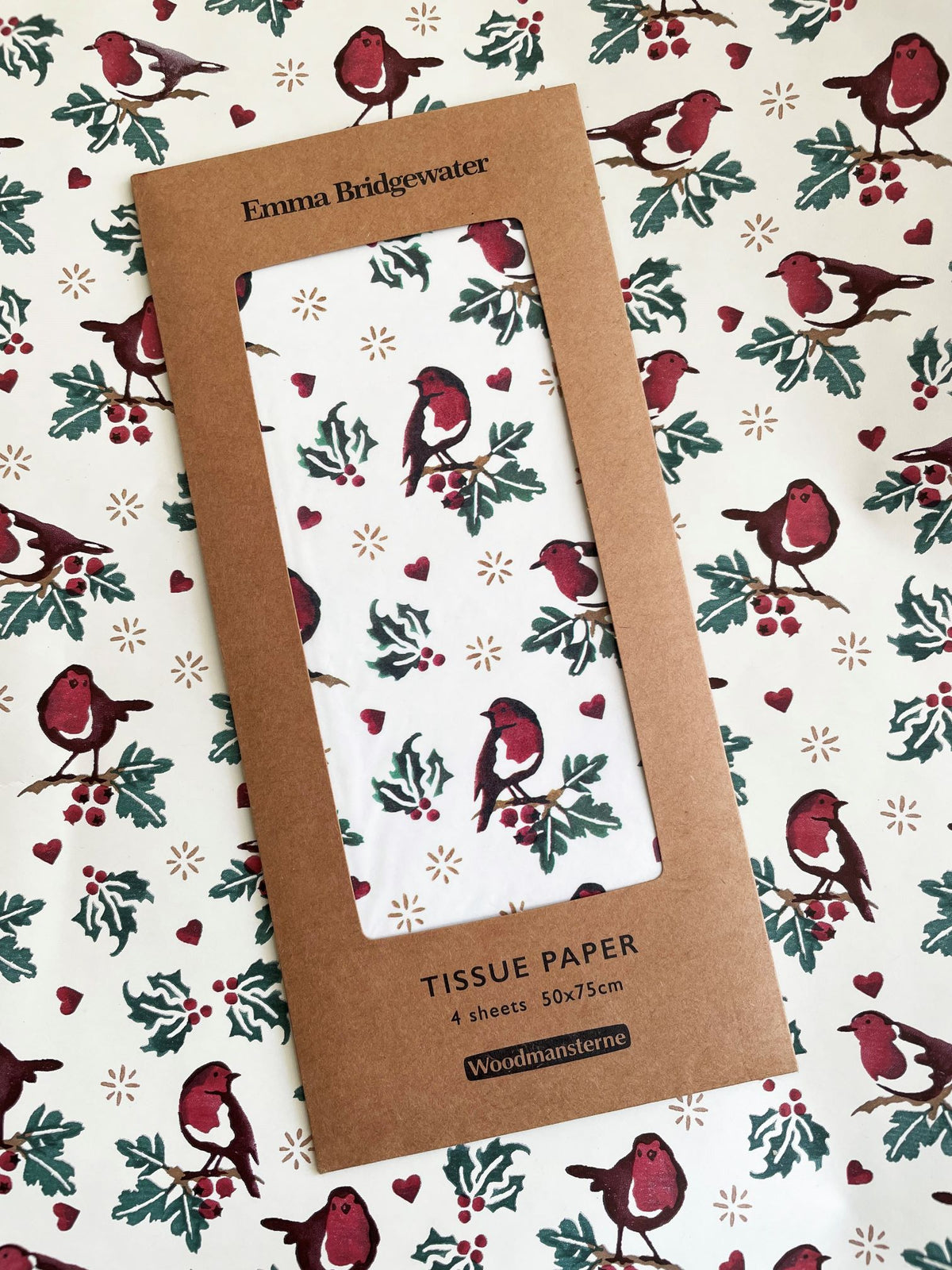 Tissue paper pack with Christmas design featuring birds and holly on a patterned background.