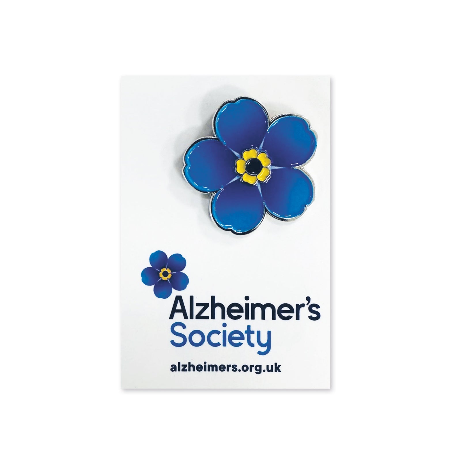 Alzheimer's Society blue flower pin badge on a white card with website URL.