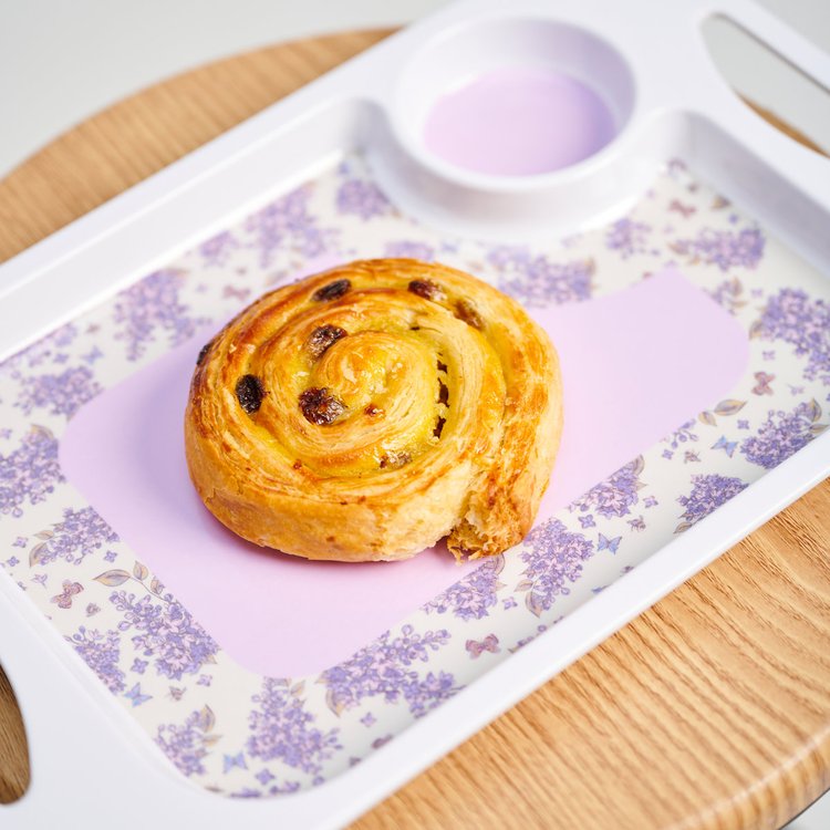 Two handled tray with lilac flower print and a Danish pastry