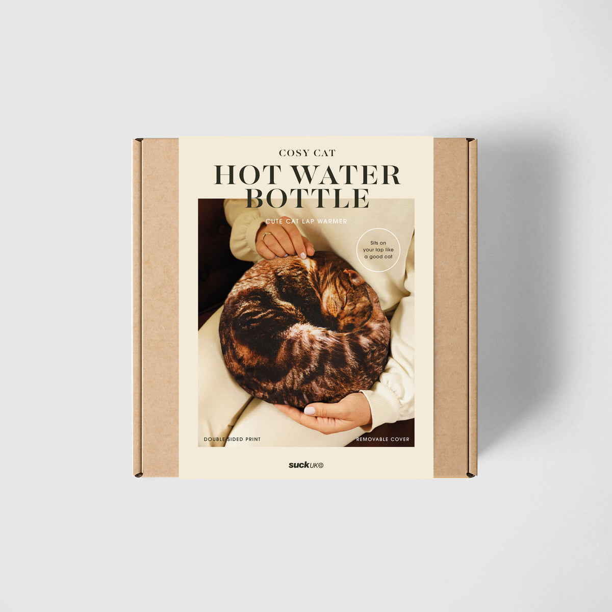 A box that contains a cat hot water bottle inside so it looks like a cat is asleep on your lap.