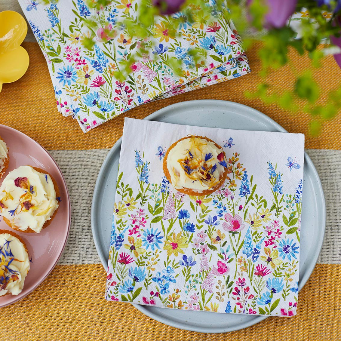 meadow napkin on a plate with a cupcake on it