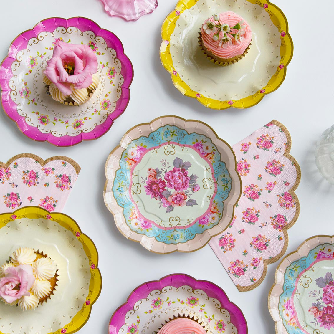 vintage plates with cupcakes on a table