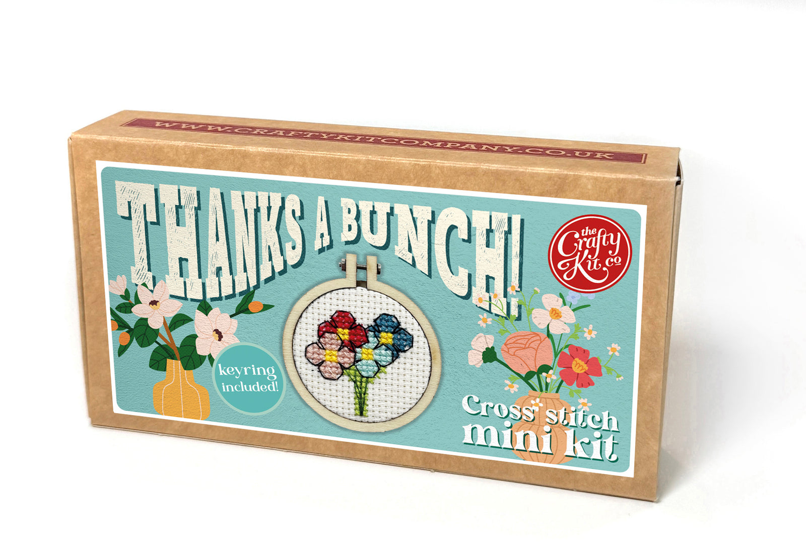 Cross-stitch mini kit packaging with floral design and text on a white background