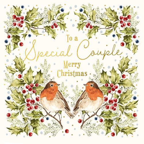 A pair of robins in a holly illustration on a Christmas card