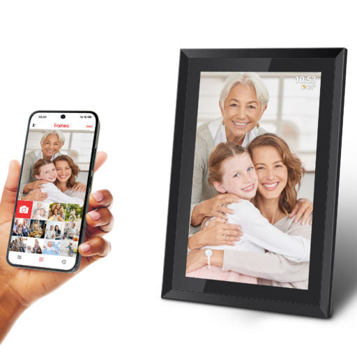 Digital photo frame displaying a family photo next to a hand holding a smartphone with a photo app.
