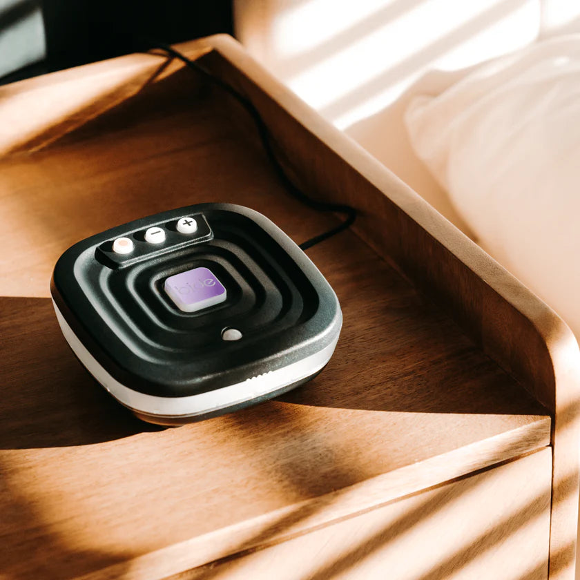 Small Bide device with light strip and buttons on a wooden side table