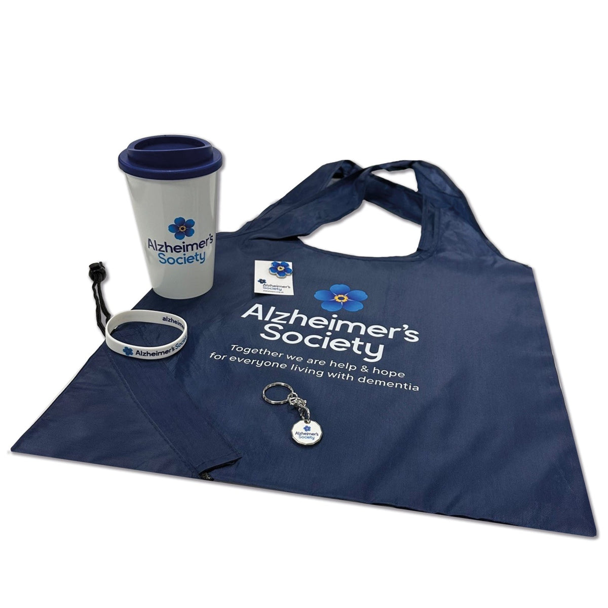 A bundle of Alzheimer&#39;s Society branded bestsellers which include a enamelled blue pin badge, white wristband, metal trolley token keyring, white travel cup with blue lid and a blue shopper which tucks into its own drawstring bag. All branded with the Alzheimer&#39;s forget-me-not logo and charity name.