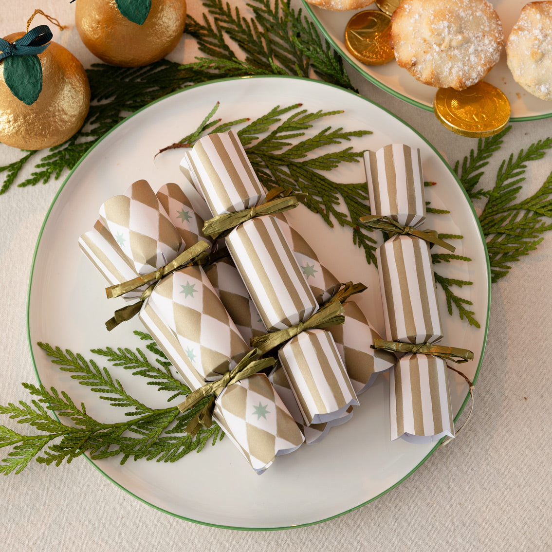 Christmas cracker on a plate with greenery and festive decorations