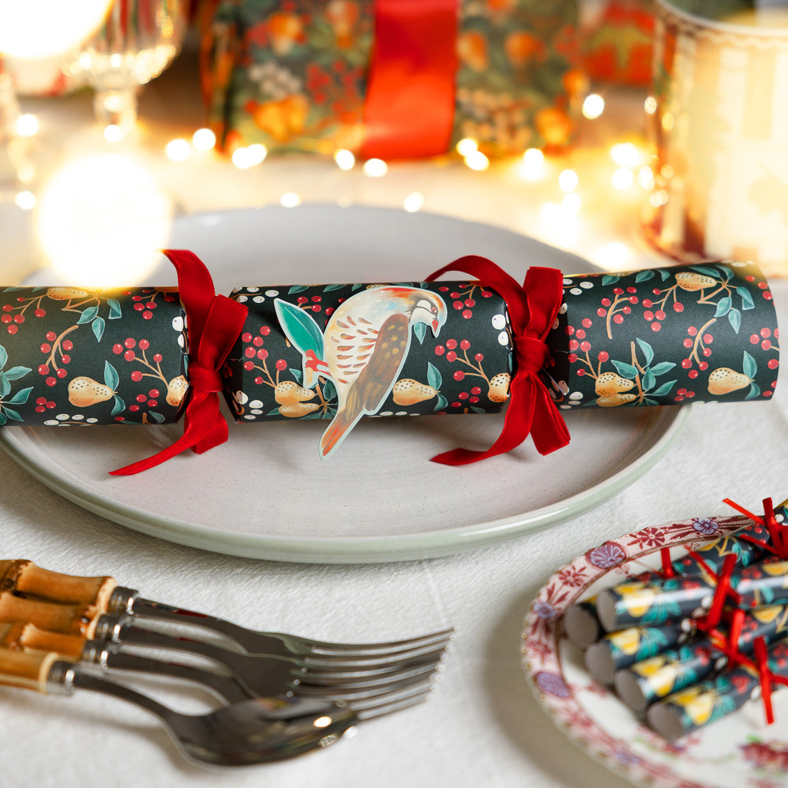 Decorative Christmas cracker on a plate with festive background