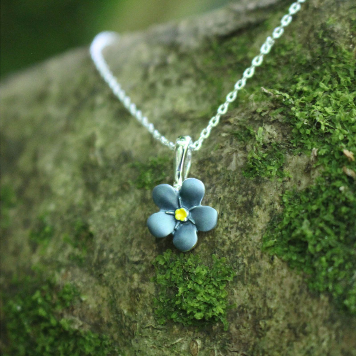 A blue Forget-me-not necklace on a branch