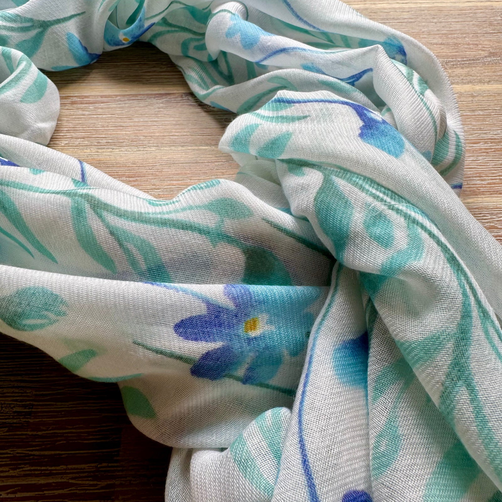 Floral patterned fabric on a wooden surface