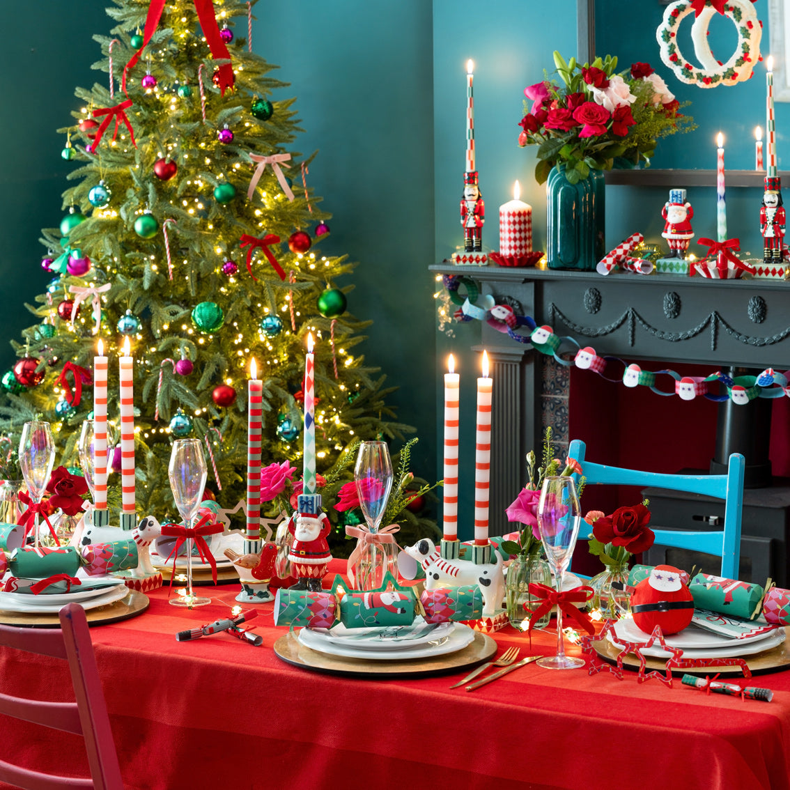 Decorated Christmas table with a tree, candles, and festive decorations.
