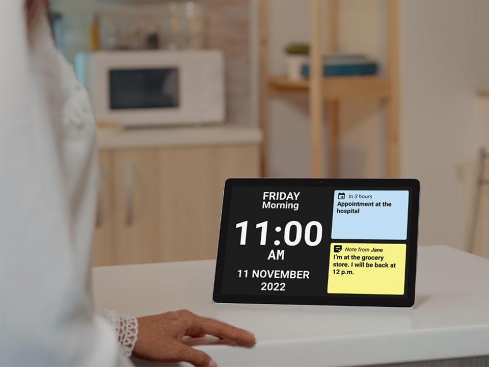 Digital display showing a schedule with a blurred kitchen background