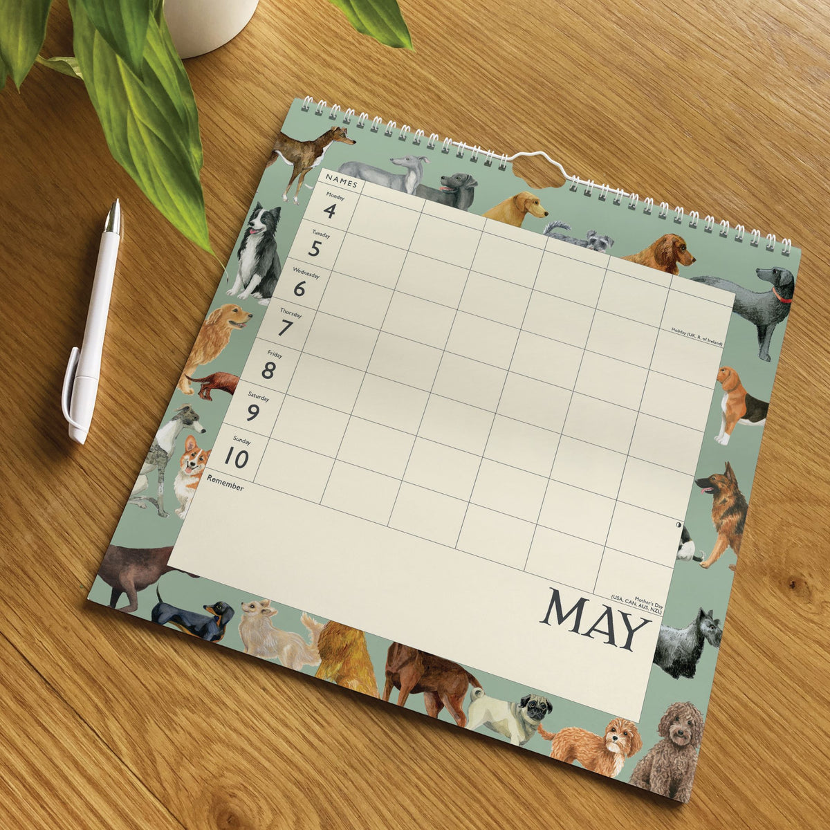 Calendar with dog pattern on a wooden surface